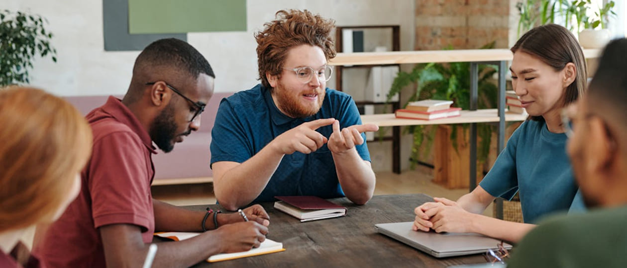 The team reviewing a project plan together around a shared table